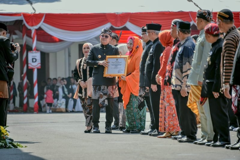 Plt Bupati Gresik, Aminatun Habibah saat menerima penghargaan dari Pj Gubernur Jawa Timur, Sabtu (12/10/2024) (Foto: Pemkab Gresik)
